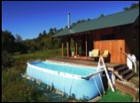 portable pool lying on the ground in front of house in garden