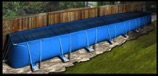 portable pool lying above the grassy ground